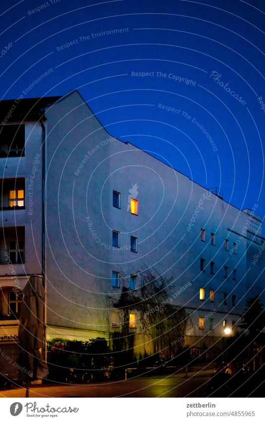 Illuminated windows Evening Old building on the outside Fire wall Dark darkness Lonely lit Facade Window House (Residential Structure) Sky Sky blue