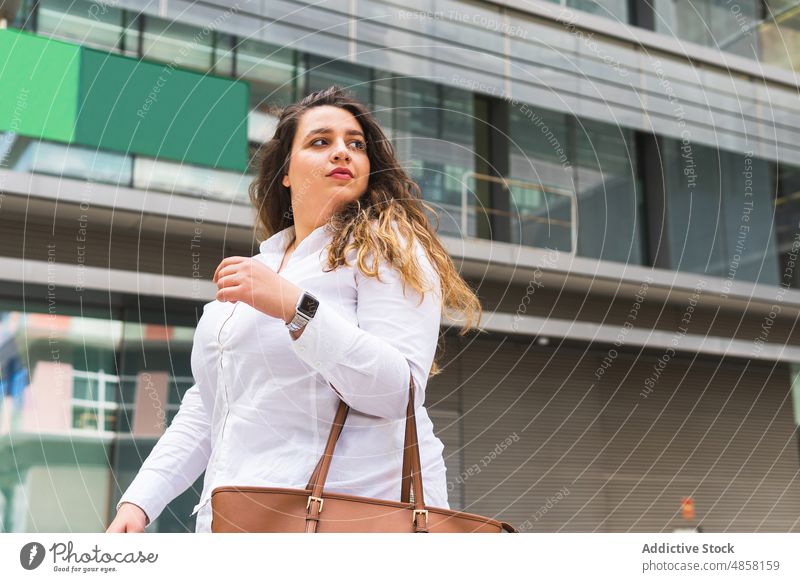 Woman standing near modern building woman street city appearance style urban fashion feminine female house glad wall construction town summer lady charming