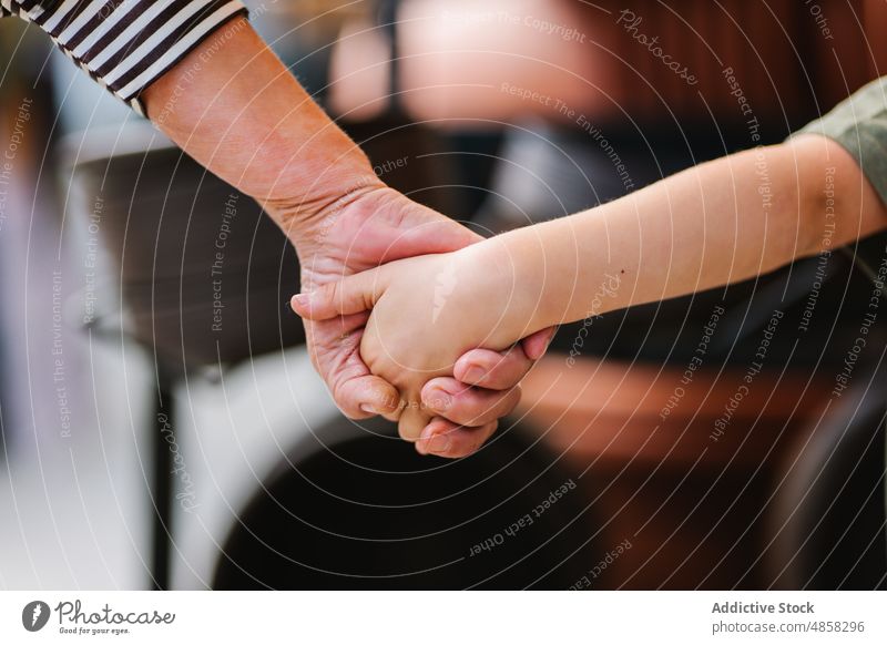 Crop grandparent and grandchild holding hands grandmother shop together visit weekend support love family relationship relax tender store trust grandma aged