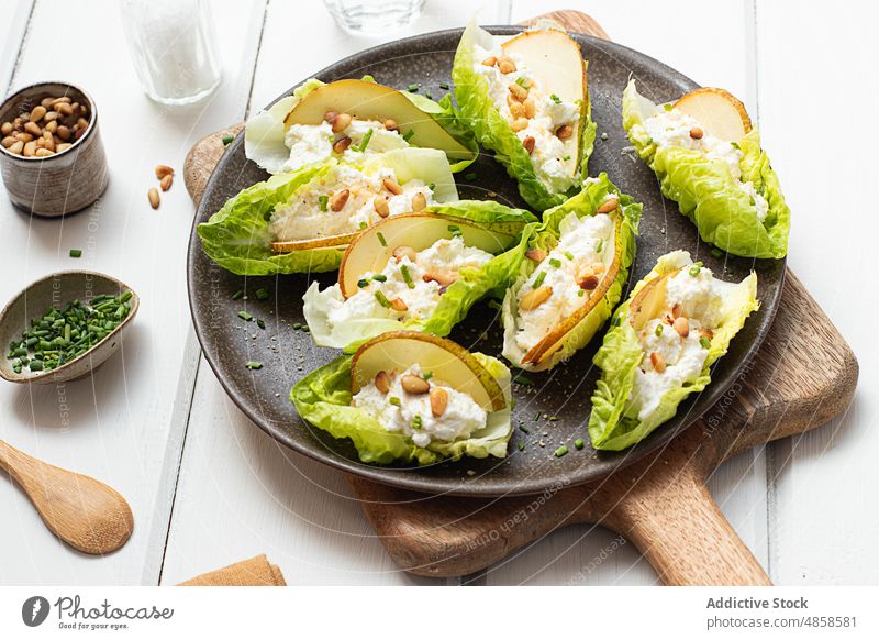 pear ricotta salad with lettuce on wooden table background tasty natural slices vegetables pinions seed cheese meal dinner ingredient green organic diet snack