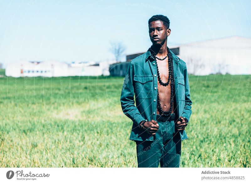 African man in denim clothes in countryside style fashion outfit tradition summer grass model casual accessory african ethnic black blue sky cloudless sky