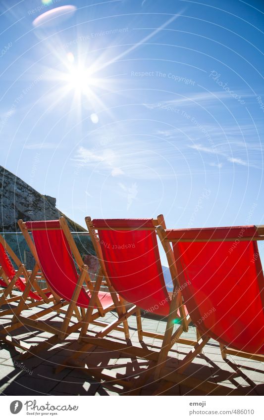 Place in the sun Environment Nature Sky Cloudless sky Sun Winter Beautiful weather Mountain Blue Red Deckchair Tourism Colour photo Multicoloured Exterior shot