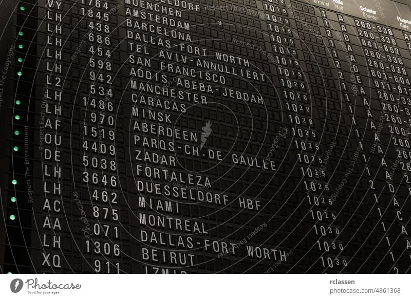 Flights timetable in airport terminal, some flights are delayed, traveling around the world by airplane, time schedule with gate and check-in number airline