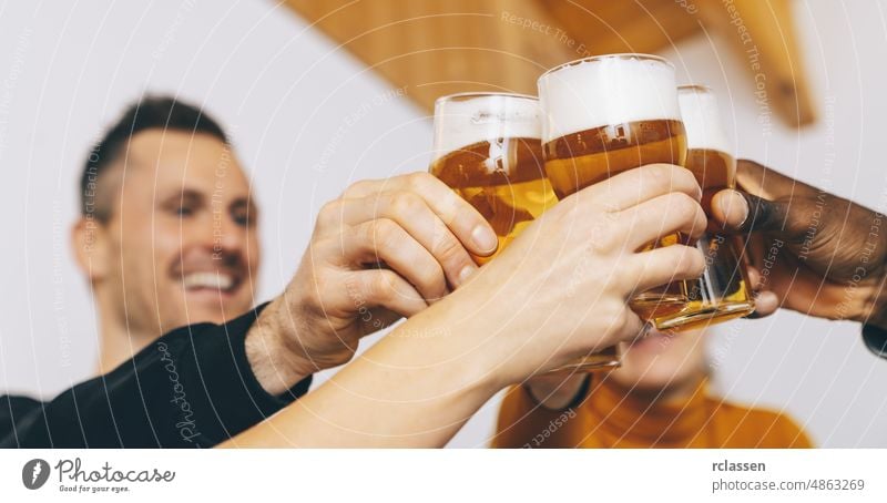 Group of friends enjoying beer glasses in brewery english pub, Young people cheering at bar restaurant, Friendship and youth concept group party hours hand