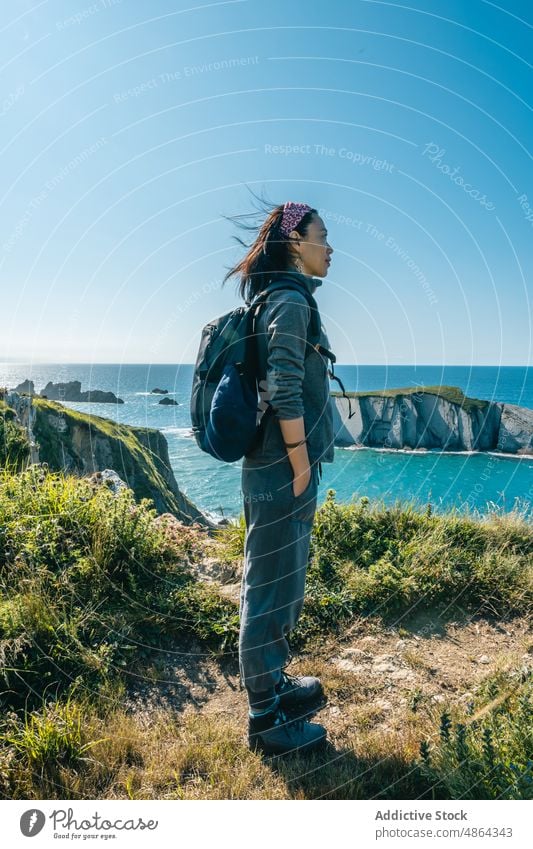 Asian girl hiking along the coast in Spring during the sunset active activity adventure alone asian asian girl background backpack beautiful camping dark hair