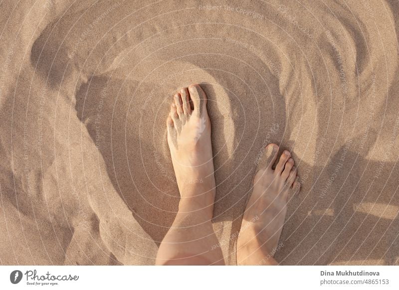 Feet on sand. Barefoot woman walking on the sandy beach. Closeup of feet on soft texture of sand. Vacation and traveling. natural healthy medical sea outdoor