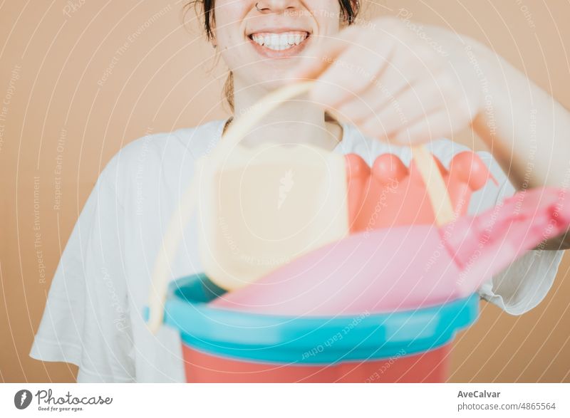 Young woman smiling happily to camera while holding cube with toys to play on the beach outdoors on summer. Color background image smile weekend resort