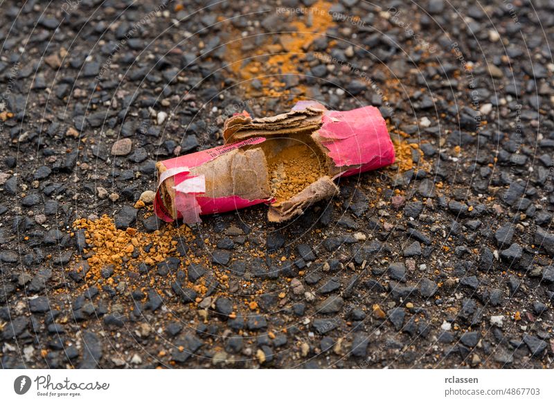 Scattered piece of a firecracker are spread on the ground. pollution abstract asia asian background belief believe burn burnt burst celebrate celebration china