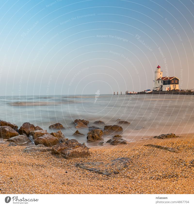 Lighthouse at the beach lighthouse signal beacon rocks coast sea marken dawn amsterdam sunset landmark north sea paard tourism shoreline Netherlands shipping