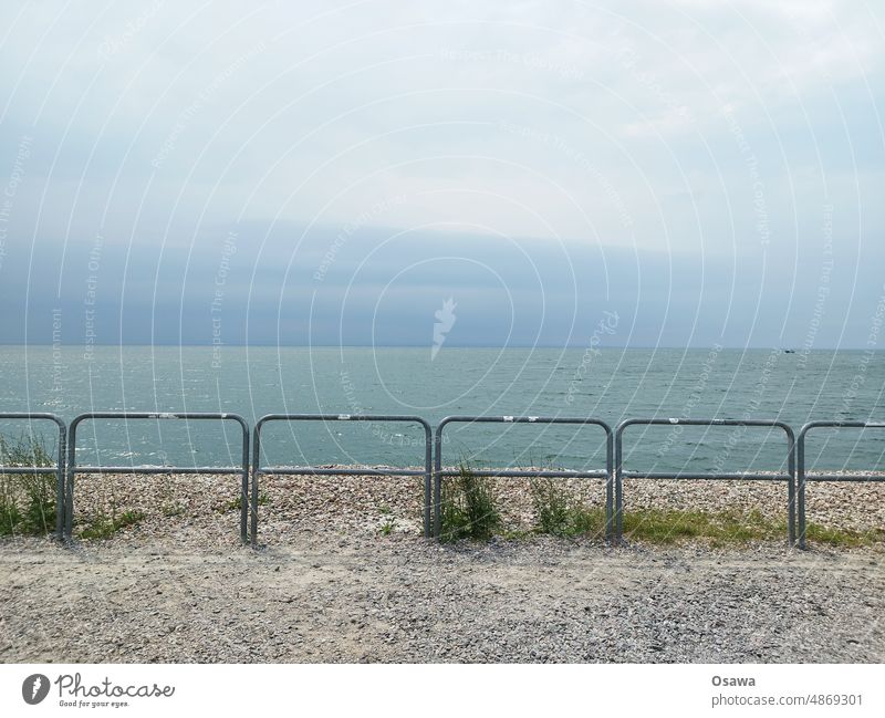 Sea behind fence Ocean Fence enclosure cordon Water Beach Nature Sky Clouds cloudy coast Landscape Sand Vacation & Travel Horizon Colour photo Day Deserted