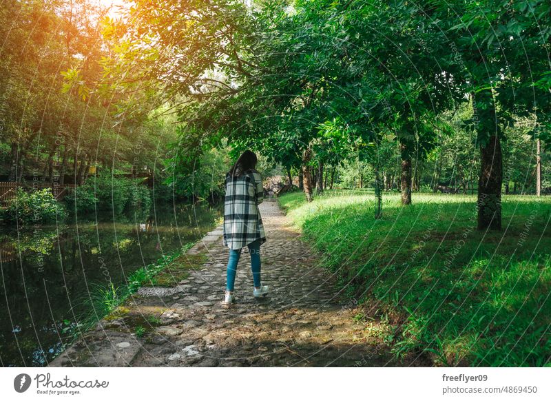 Young woman walking by a path along the river hiking forest nature alone one person people outdoors hike girl happy family timberland together park healthy