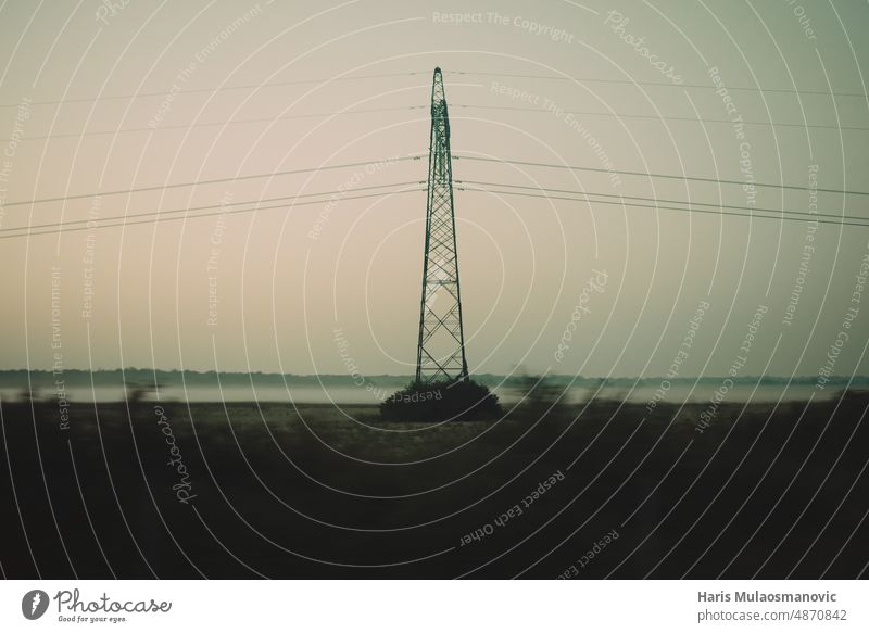 Electricity power pole in mist field in sunrise Energy Sustainability land earth ground dawn Misty atmosphere future living price