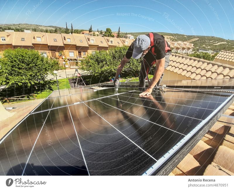 installation of solar panels on the roof of a house, phone shot sun installer energy renewable man people work efficiency men industry outdoors professional