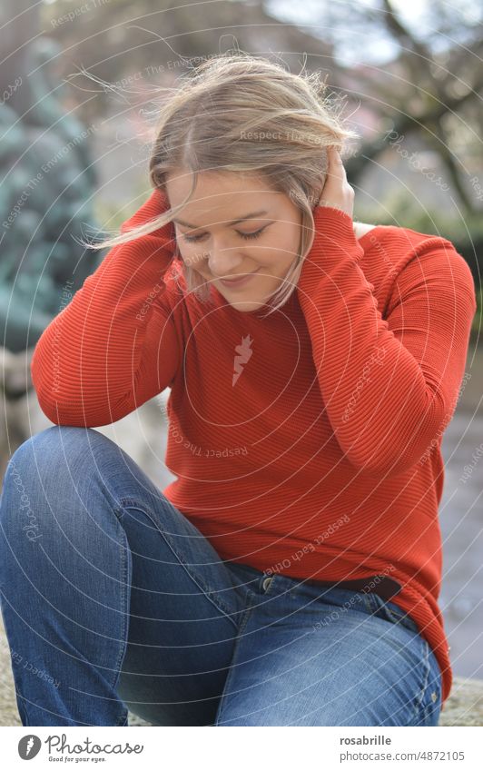 likeable young blonde woman in orange sweater smiles Woman youthful Blonde Smiling Congenial naturally Authentic portrait Happiness Attractive Contentment