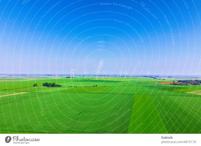 Windmill turbines in green field, Wind energy concept wind windmill farm alternative energy generator generation factory sunlight background electricity power