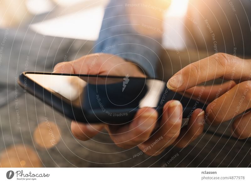 Close up of women's hands holding cell telephone with blank copy space scree for your advertising text message or promotional content, hipster girl watching video on mobile phone during coffee break