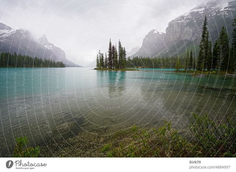 Spirit Island in Maligne Lake, Jasper National Park, Alberta, Canada, under gray skies Lake Maligne Jasper national park Lakeside glacial lake Mountain