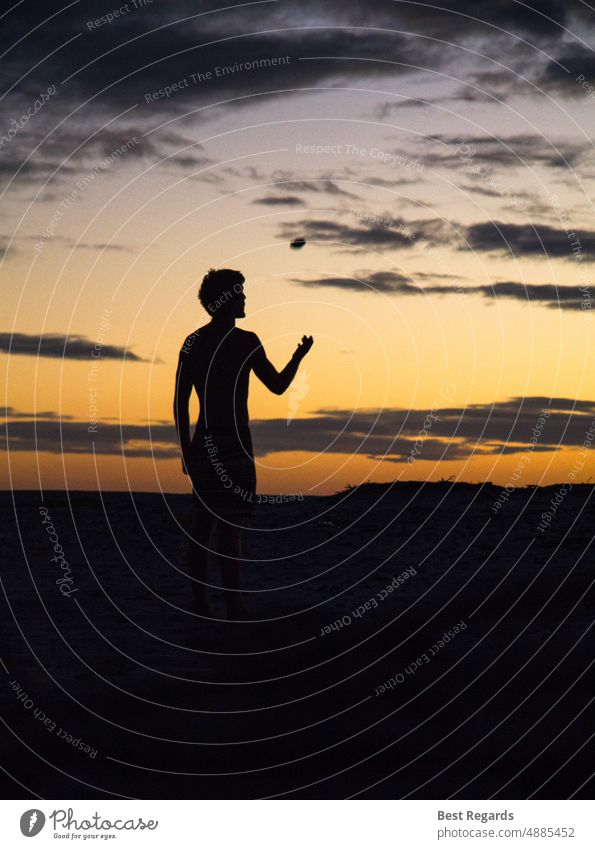 Silhouette man on the beach throwing a stone Sunset silhouette Clouds Man meditate happiness freedom travel people contrast living young Man boy ocean Nature