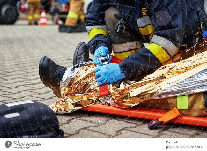 Rescuers provide first aid to the victim during car road accident corpse body dead police firefighter rescuer bag black caution killed motorway tape assistance