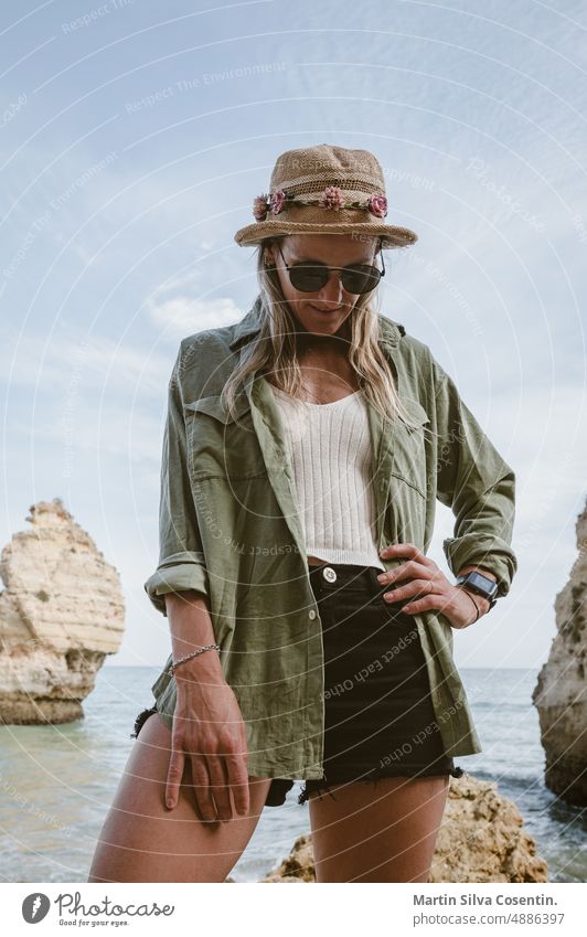 Woman in the Beautiful Praia da Mesquita in the Algarve in Portugal algarve atlantic atlantic ocean beach beautiful blue calcareous rock chapel church cliff