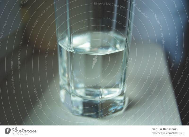 Half glass of water standing on the counter drink liquid empty freshness table half object background beverage cup no people transparent refreshment blue cold