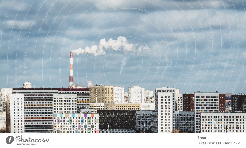 Smoking factory chimney, modern residential buildings of bedroom suburb in big city, urban skyline cityscape dormitory district horizontal downtown view midtown