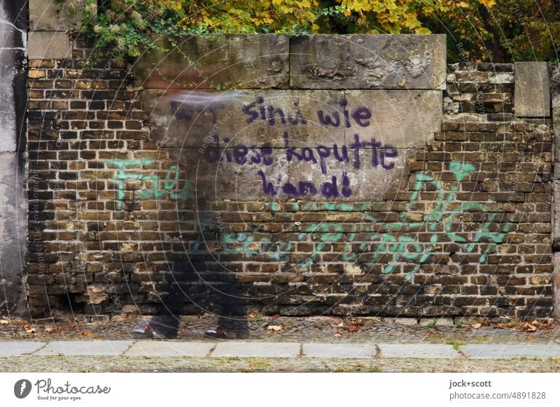 We are like this broken wall, pedestrian walks past the old wall of the cemetery Wall (barrier) Cemetery Street art Kreuzberg Berlin Philosophy Creativity