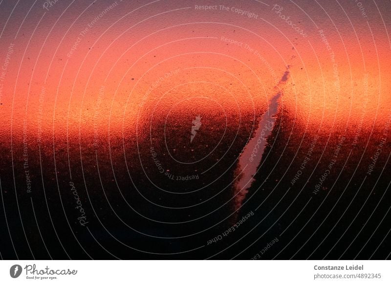 Sunset through rain wet window pane with red black gradient. Orange Impressive blurriness Horizon Light Structures and shapes Damp Drops of water Wet Slice