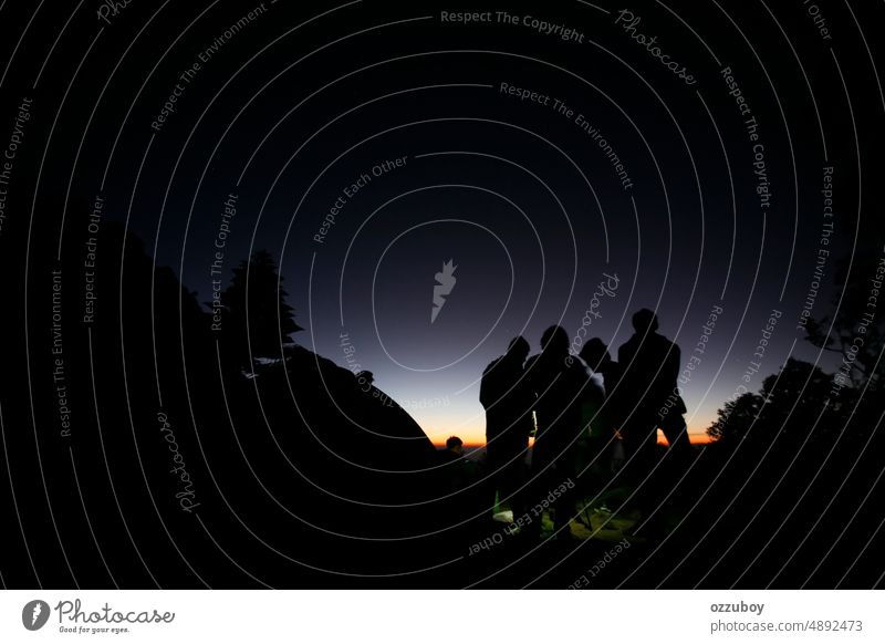 Hikers or tourists stands on mountain top at sunset abstract activity adventure back background camping community concept copy space dusk enjoy evening freedom