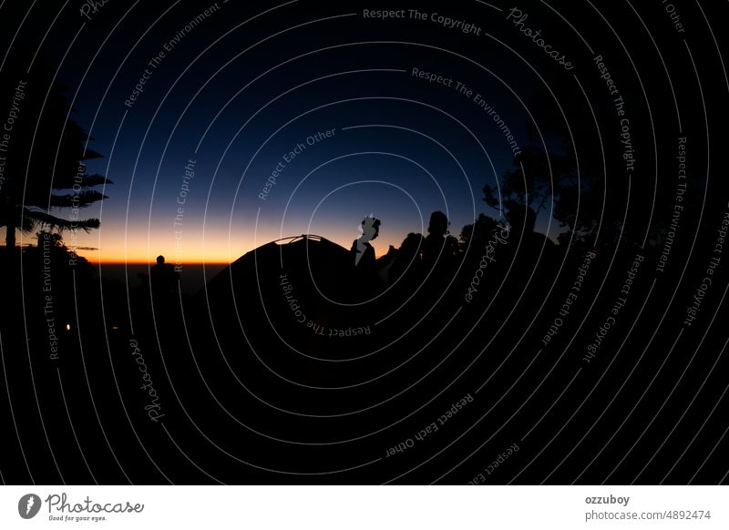 Hikers or tourists stands on mountain top at sunset abstract activity adventure back background camping community concept copy space dusk enjoy evening freedom