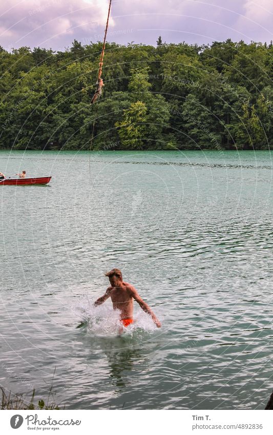 a man dives into the lake, jumping from a rope liepnitzsee Summer Man Jump Water Exterior shot Colour photo Nature Lake Swimming & Bathing Joy Dive