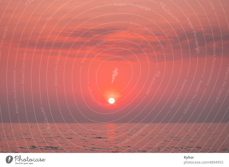 Sundown Above Sea Horizon At Sunset. Natural Sunrise Sky Warm Colors Over Ocean. Sun Over Sea Waters beautiful bright calm color copy space evening horizon hot