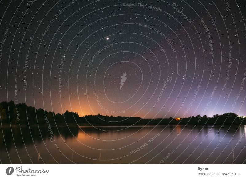 Village Novoye Lyadno, Lyepyel District, Vitebsk Province, Belarus. Real Colorful Night Stars Above Lepel Lake. Natural Starry Sky Background Backdrop Landscape