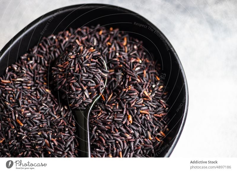 Raw organic black rice bowl food raw asian food table wholegrain cereal ingredient uncooked vegetarian diet oriental wild eating healthy background closeup dry