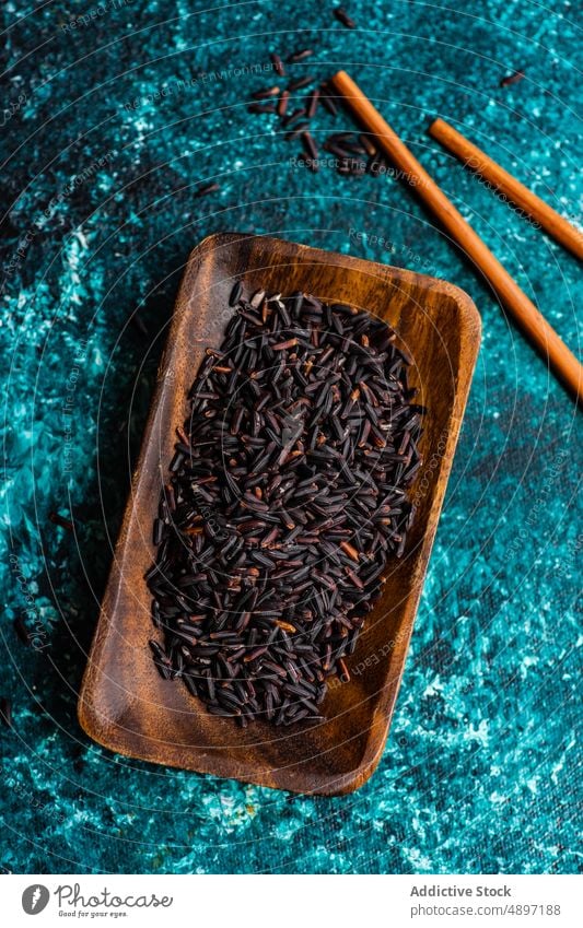 Raw organic black rice food raw asian food table wholegrain cereal ingredient bowl uncooked vegetarian diet oriental wild eating healthy background closeup dry