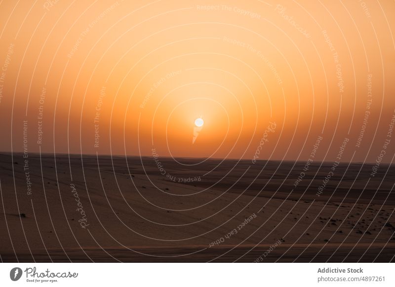 Sunset sky over dry desert sunset arid evening bright breathtaking orange sand doha qatar middle east twilight dusk nature picturesque landscape terrain vivid