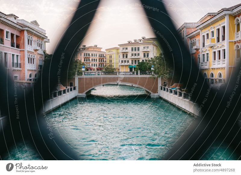 Canal with bridge on town street canal house water building mesh wall architecture doha qatar ornament residential morning river flow dwell channel district