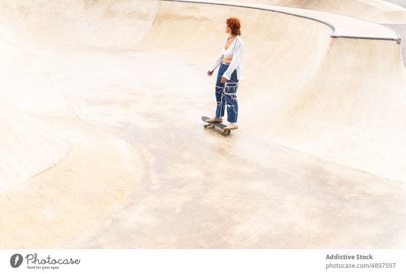 Woman riding skateboard in skate park woman ride skateboarder hobby training sport ramp pastime move energy sporty motion dynamic action skill practice active