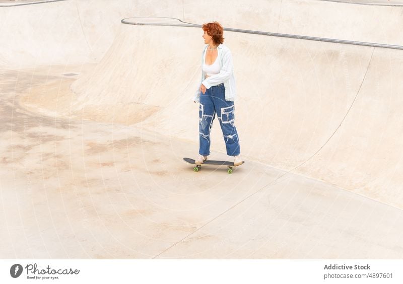 Woman riding skateboard in skate park woman ride skateboarder hobby training sport ramp pastime move energy sporty motion dynamic action skill practice active