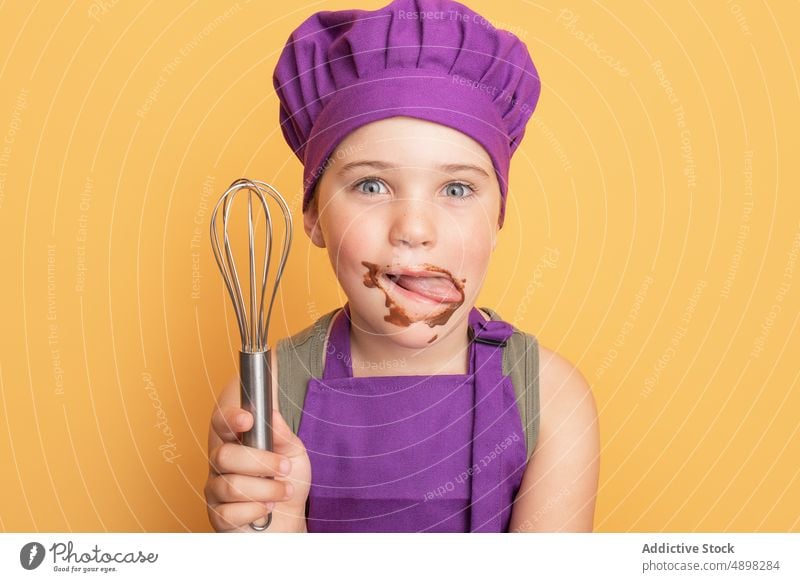 Messy boy licking chocolate off face kid chef messy whisk sweet cook treat mischievous indulge sugar utensil smile flavor tasty yummy happy delicious dessert