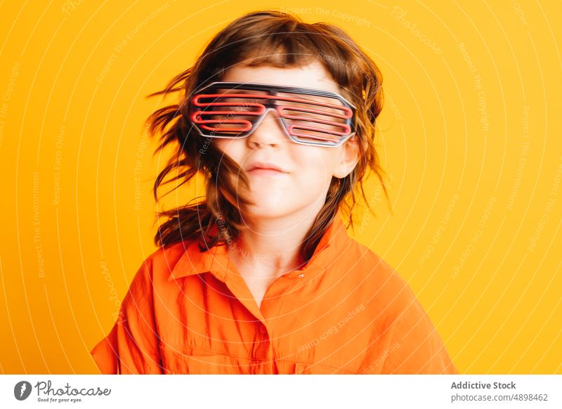 Little kid in neon glasses futuristic party goggles colorful bright childhood glow costume little vibrant festive event cute adorable sci fi appearance