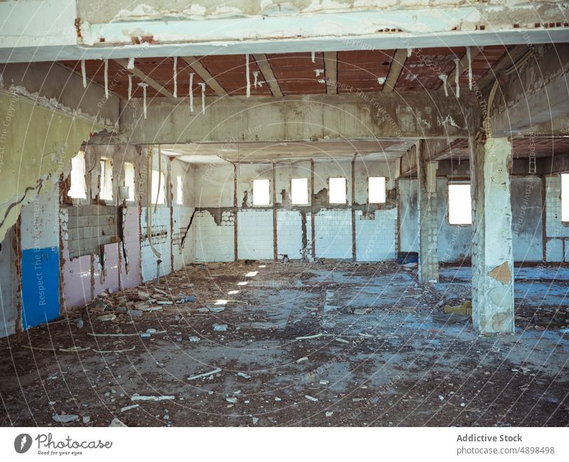 Interior of abandoned industrial building interior sunset shabby concrete column floor dark grunge structure desolate construction weathered rough pillar