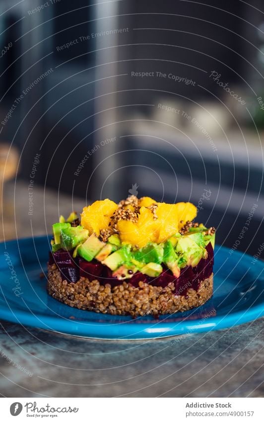 Vegan salad on blue plate layer serve vegan healthy food diet dish kitchen natural avocado mango beet quinoa gastronomy fresh delicious yummy vitamin appetizing