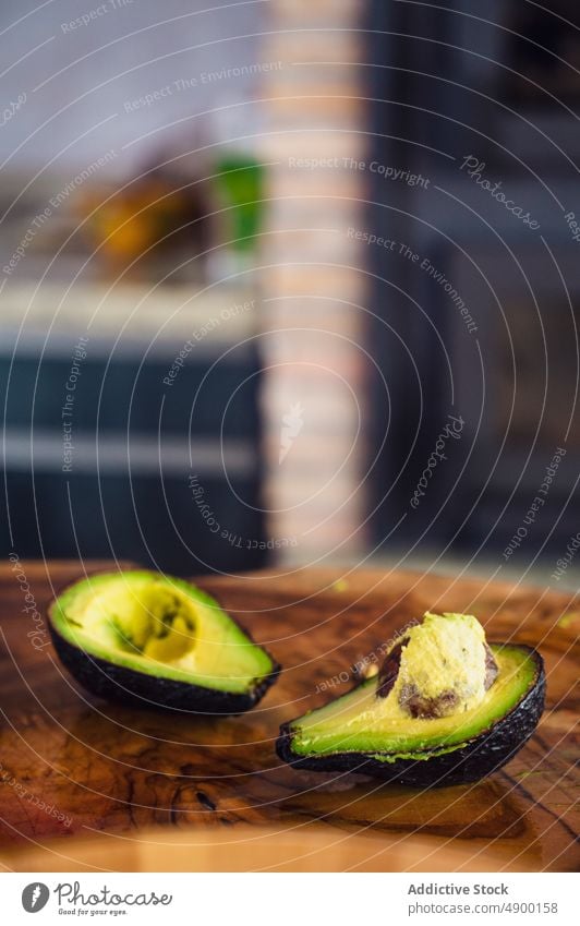 Halved avocado on lumber slab half fresh wooden kitchen healthy food diet seed ripe ingredient home organic vitamin vegan prepare raw natural product vegetarian