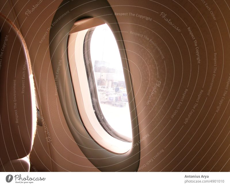 Typical airplane window from passenger seat view and dark background for wallpaper dreaming atmosphere concept flight sunset above aerial aeroplane aircraft