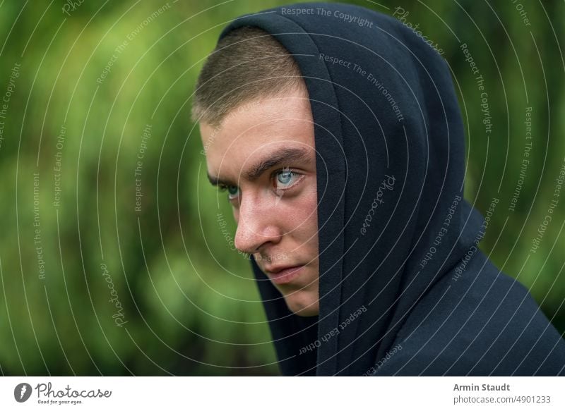 portrait of young serious man wearing hoodie look teenager looking male beautiful casual caucasian outdoor confident model lifestyle sunlight sunbeam thoughtful