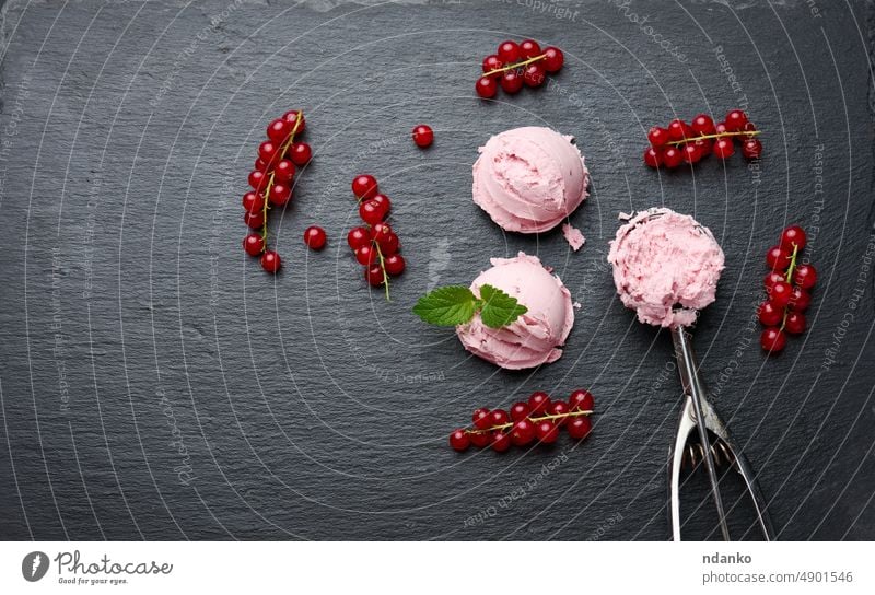 Pink ice cream balls on a black stone board, red currant berries nearby, top view food dessert sweet scoop cold vanilla favor creamy tasty dairy delicious soft