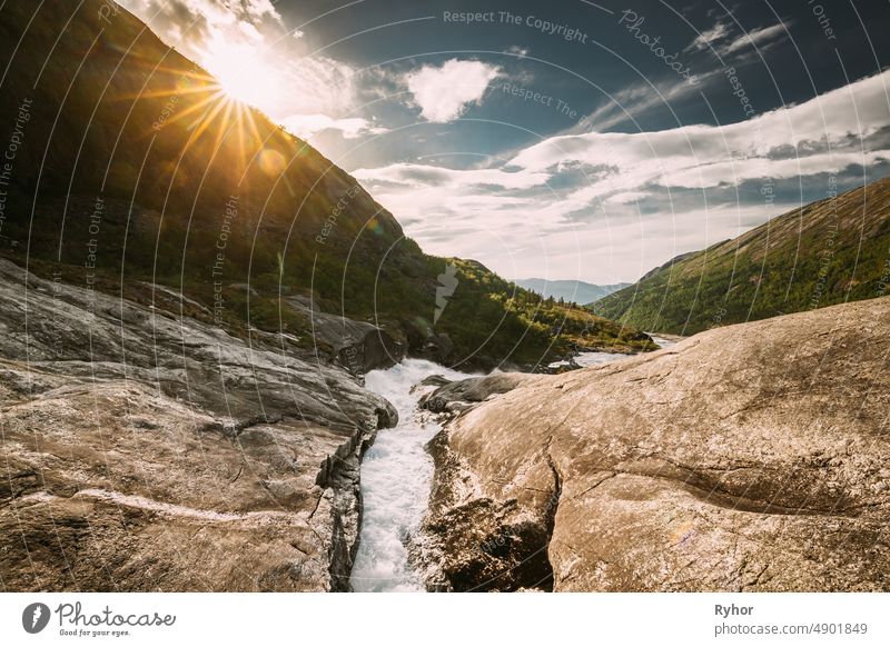 Kinsarvik, Hordaland, Norway. Water Stream Through Rocks In Hardangervidda Mountain Plateau. Sun Sunshine Above Rocky Landscape In Summer Sunny Day. Famous Norwegian Landmark And Popular Destination. Sotefossen