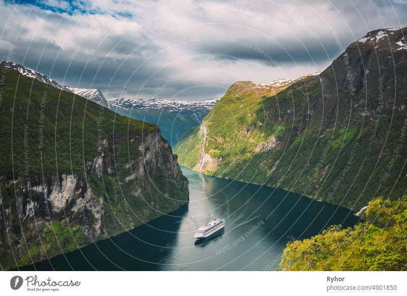 Geirangerfjord, Norway. Touristic Ship Ferry Boat Cruise Ship Liner Floating Near Geiranger In Geirangerfjorden In Summer Day. Famous Norwegian Landmark And Popular Destination