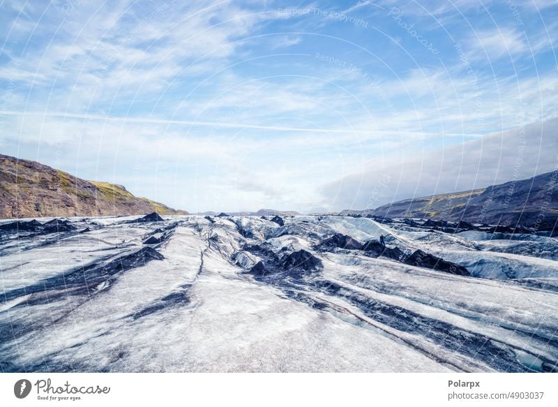 Solheimajokull glacier in bright daylight arctic scene stone frozen melting hiking mountain chilling coldness surface horizon sunset skies wild hike icelandic